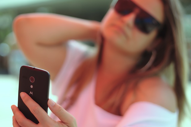 Young woman taking a selfie for social media