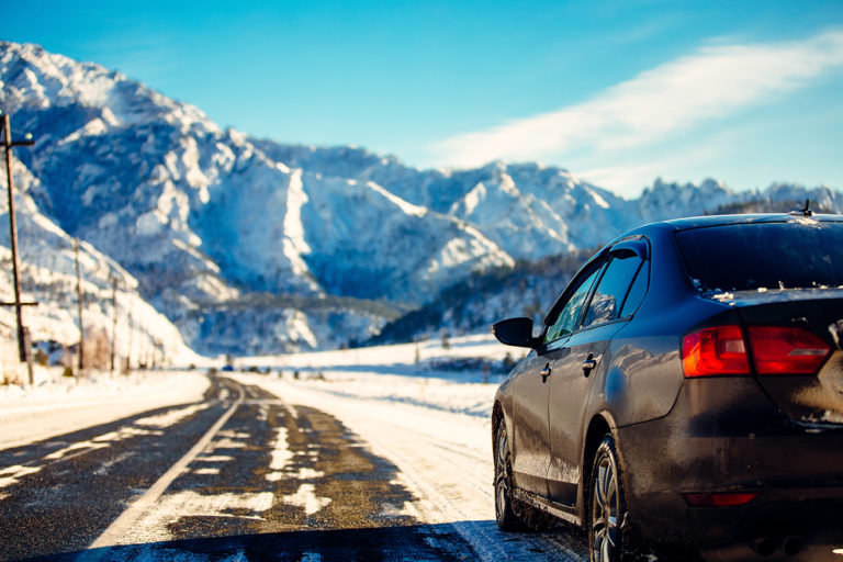 The brown car in the mountains the road Extreme Winter Road Conditions