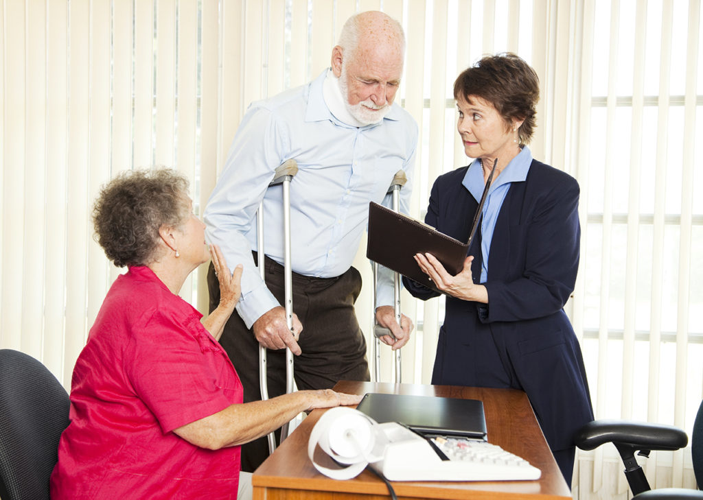 personal injury attorney discusses case with clients