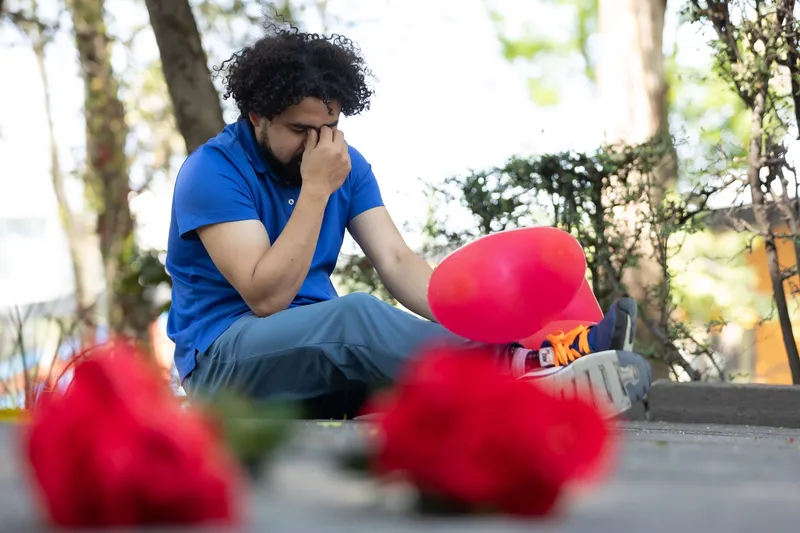 A man sitting at graveyard mourning