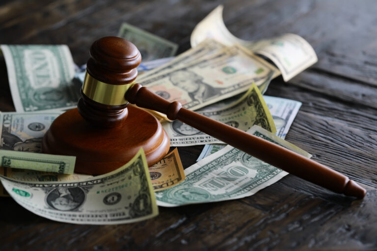 judge gavel and money on brown wooden table concept