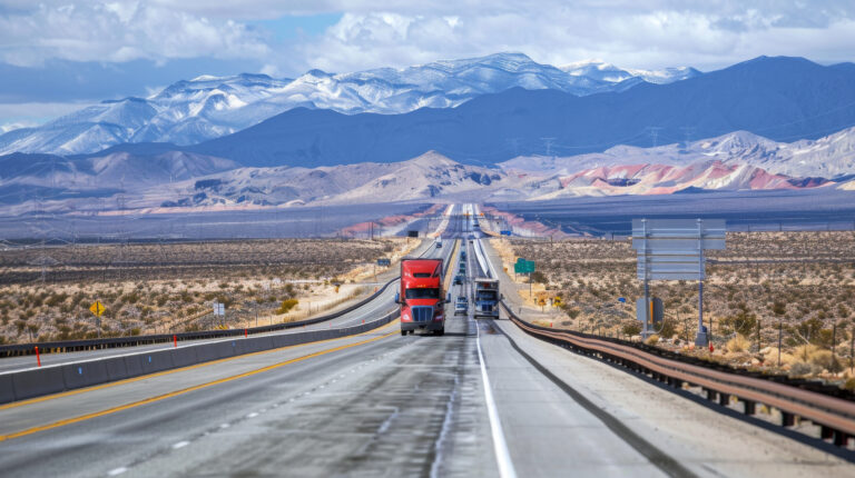 long-highway-semi-trucks-mountains