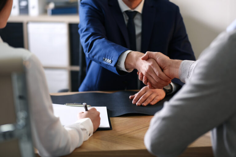 Male lawyer working with clients in office